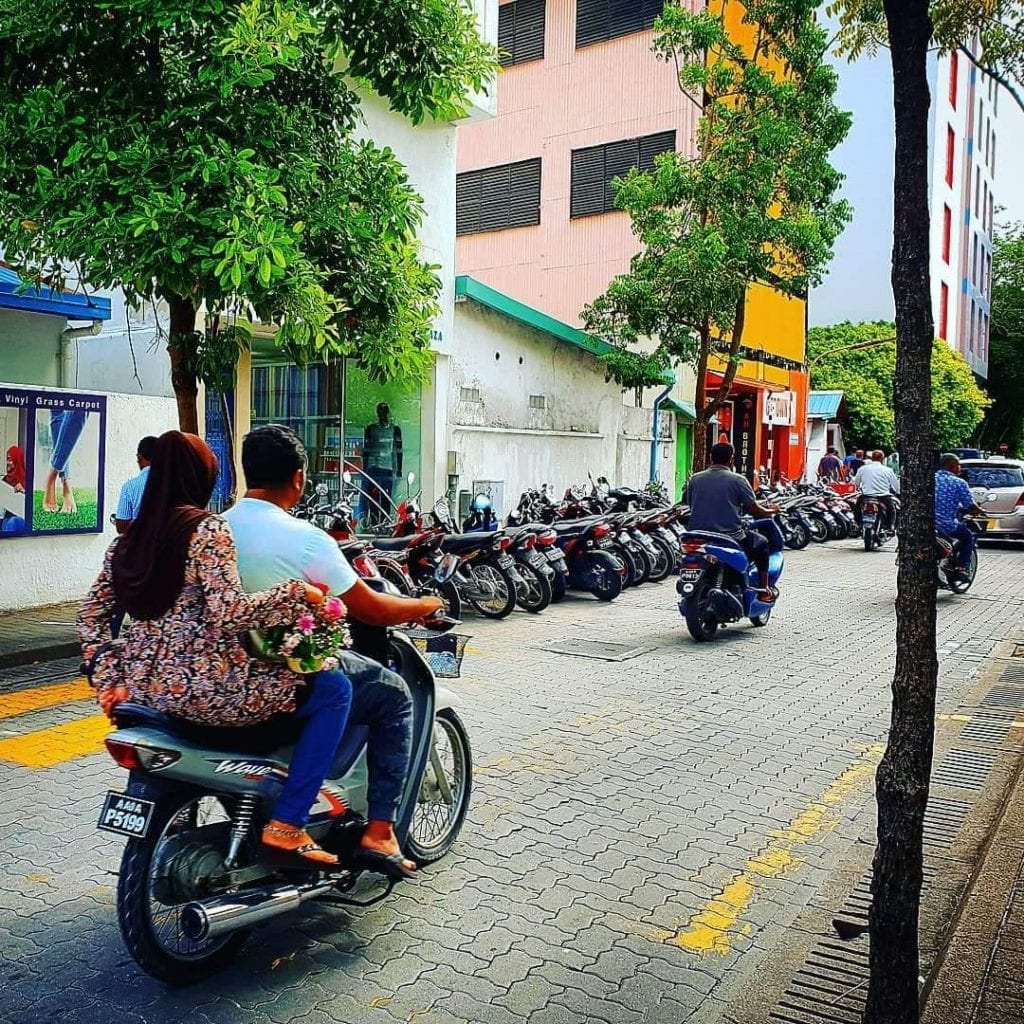 male city with many motorbikes and colored buildings
vilamendhoo island resort review