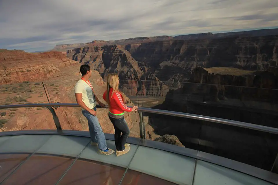 travel USA on a budget - standing on the sky walk in Grand Canyon looking out to the canyon walls and Colorado river below