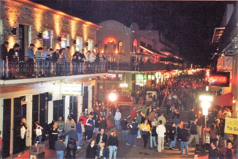 Bourbon street at night with hundreds of people on the street