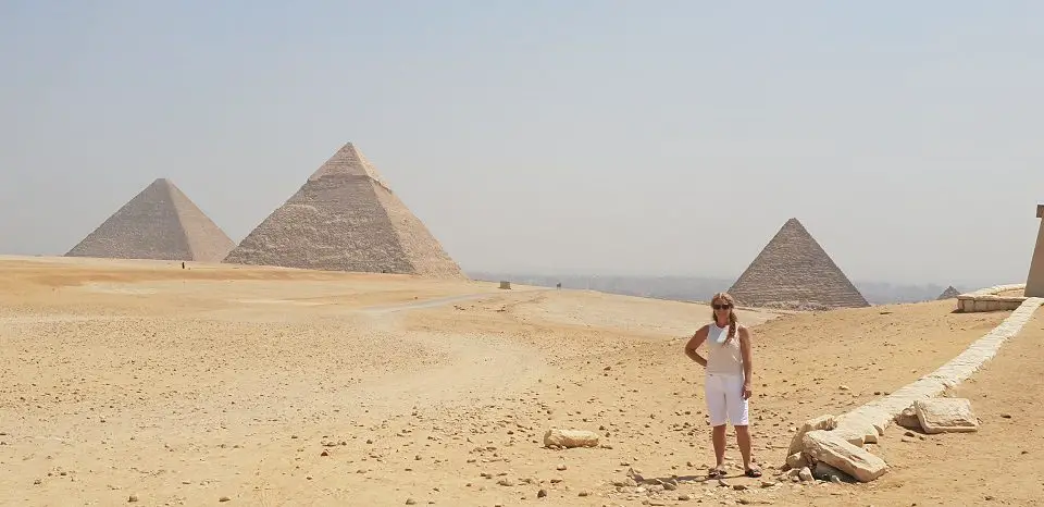 stanindg in the desert near the pyramids 