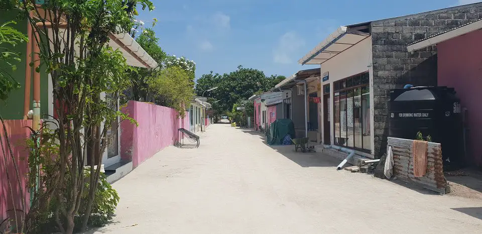 maldives itinerary - local island street with shops either side