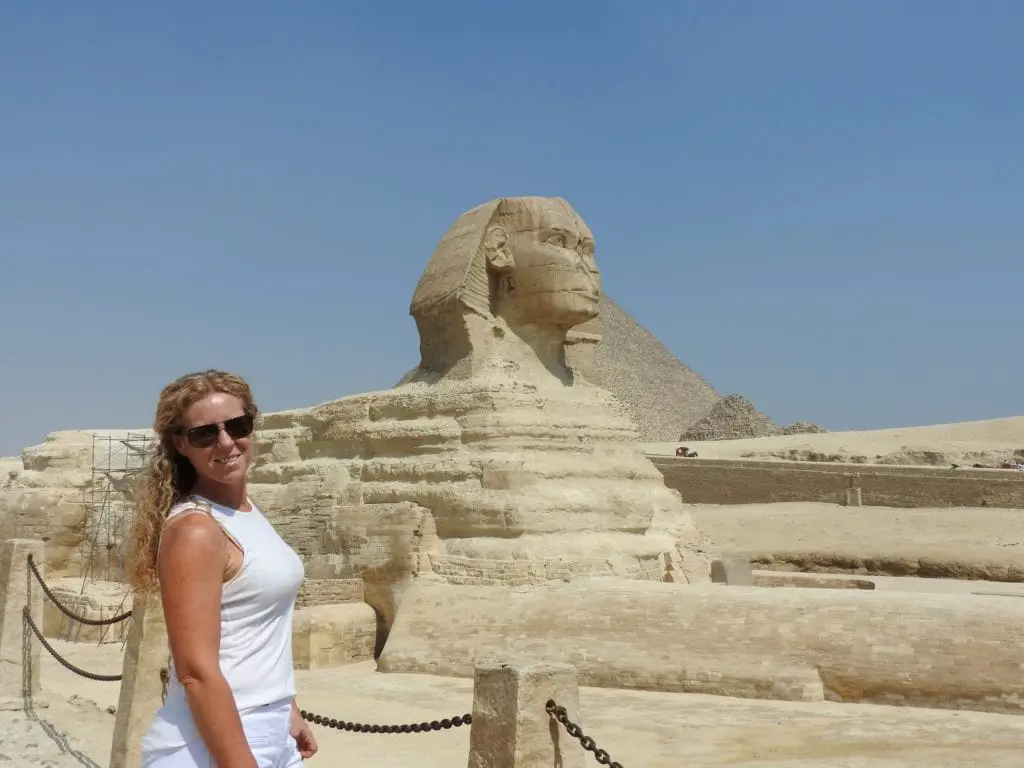 standing in front of the sphinx with the Pyramid in the background