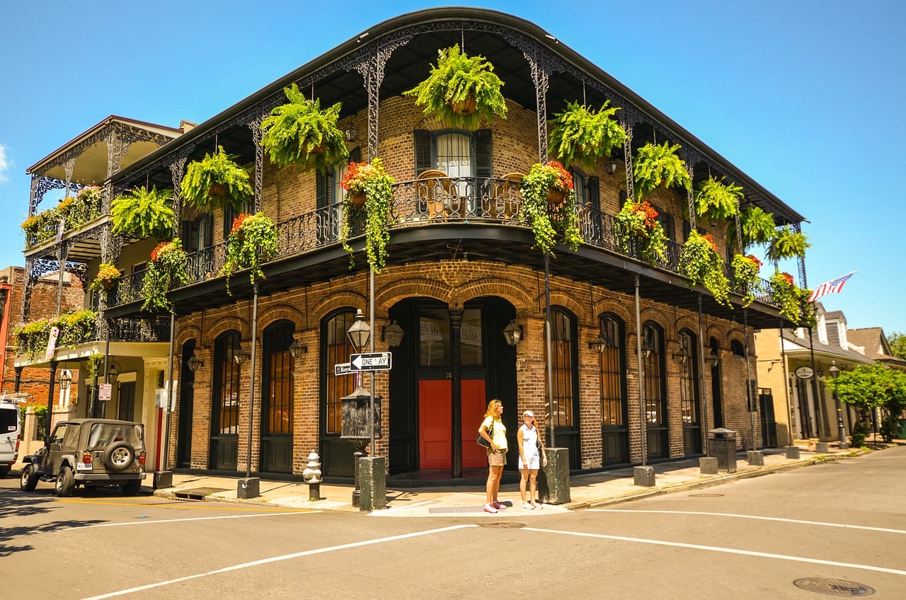 historic building with green hanging baskets