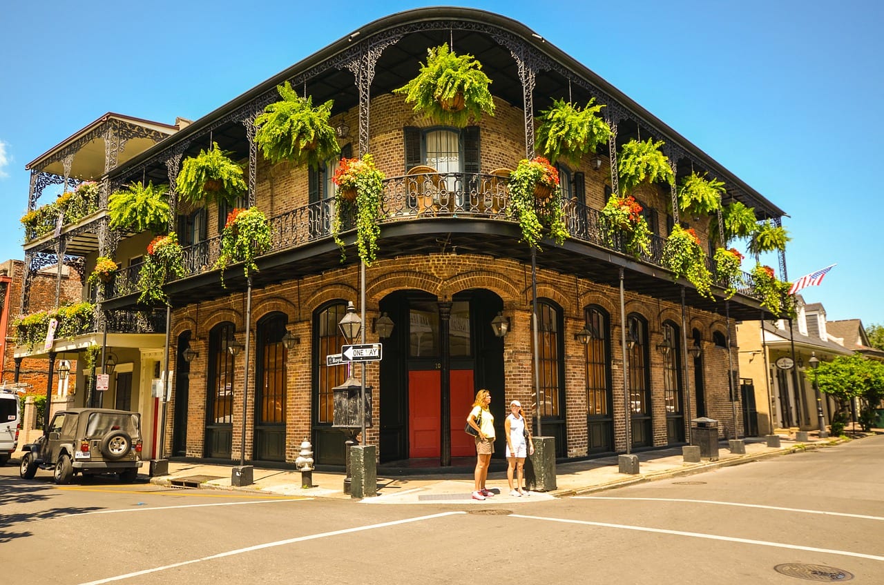 historic building with green hanging baskets