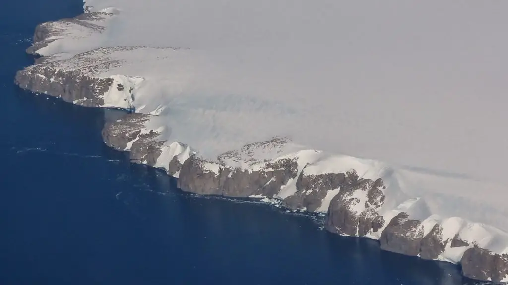  White snow and rocky coast line