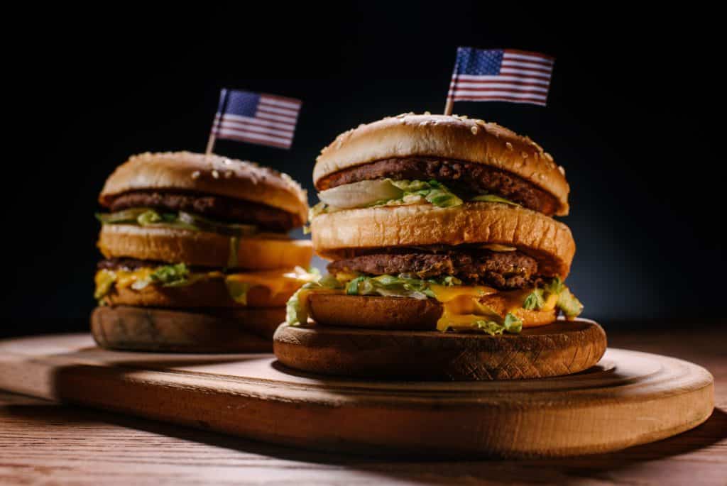 Visiting America for the first time - 2 huge hamburgers with USA flags on top