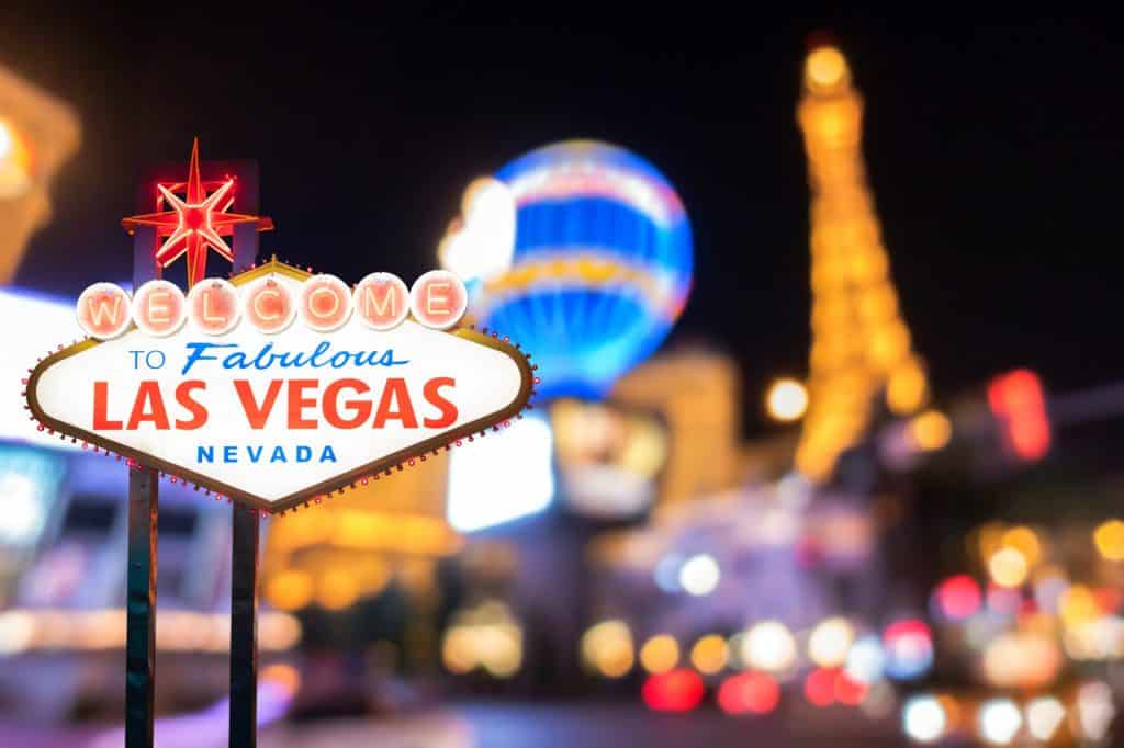 travel USA on a budget = Las Vegas sign with Paris hotel in the background