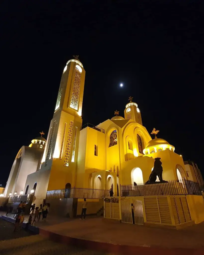 White church lit up at night.