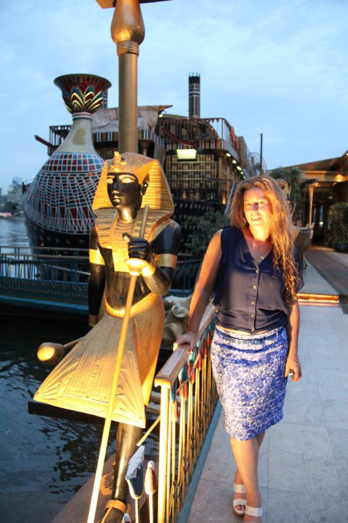 Standing beside a boat on the Nile in Cairo. The boat is adorned with Egyptian decoration.