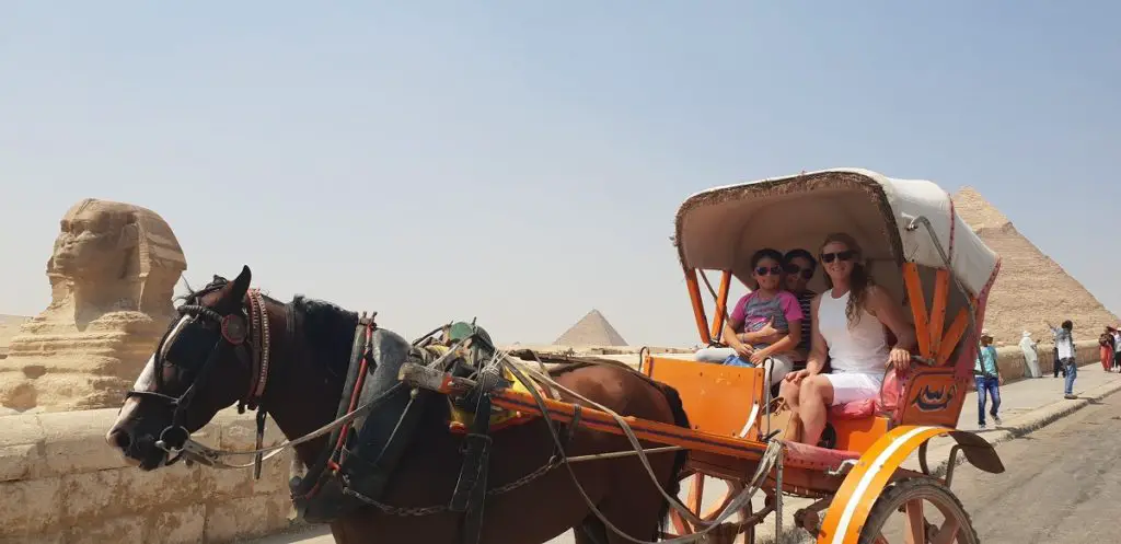 Taking a horse and carriage ride at the Pyramids with my young neice. You can see the Sphinx on the left and Great Pyramids on the right.