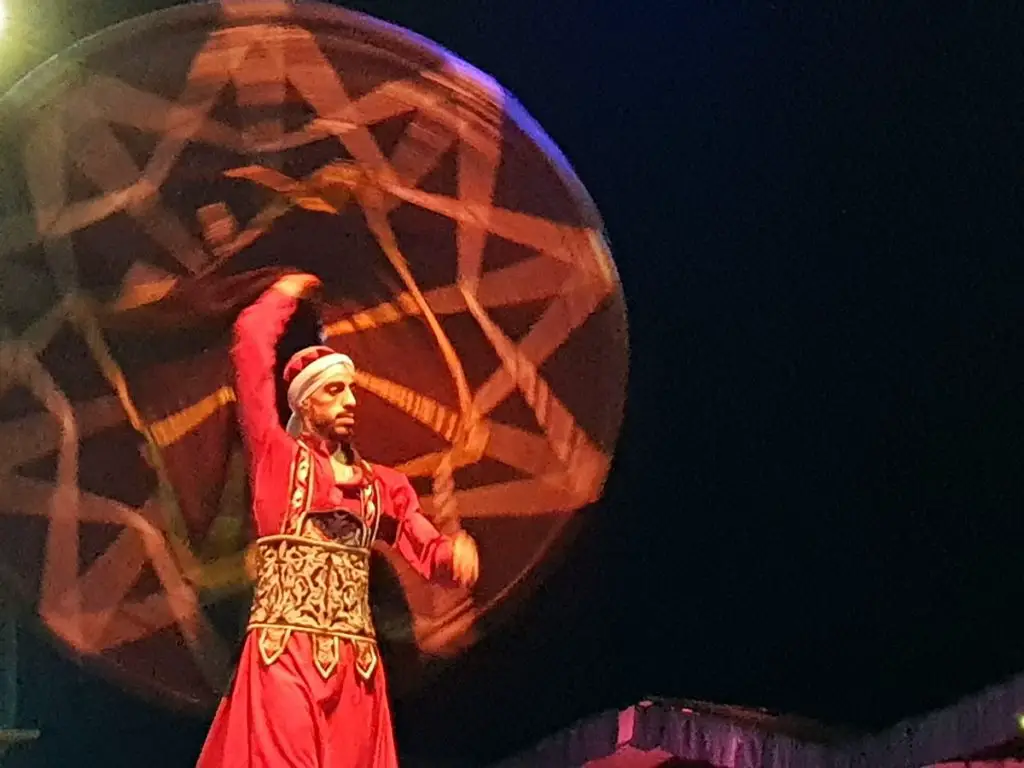 A Tanoura dancer spins his circular skirt behind his head -Egypt experiences