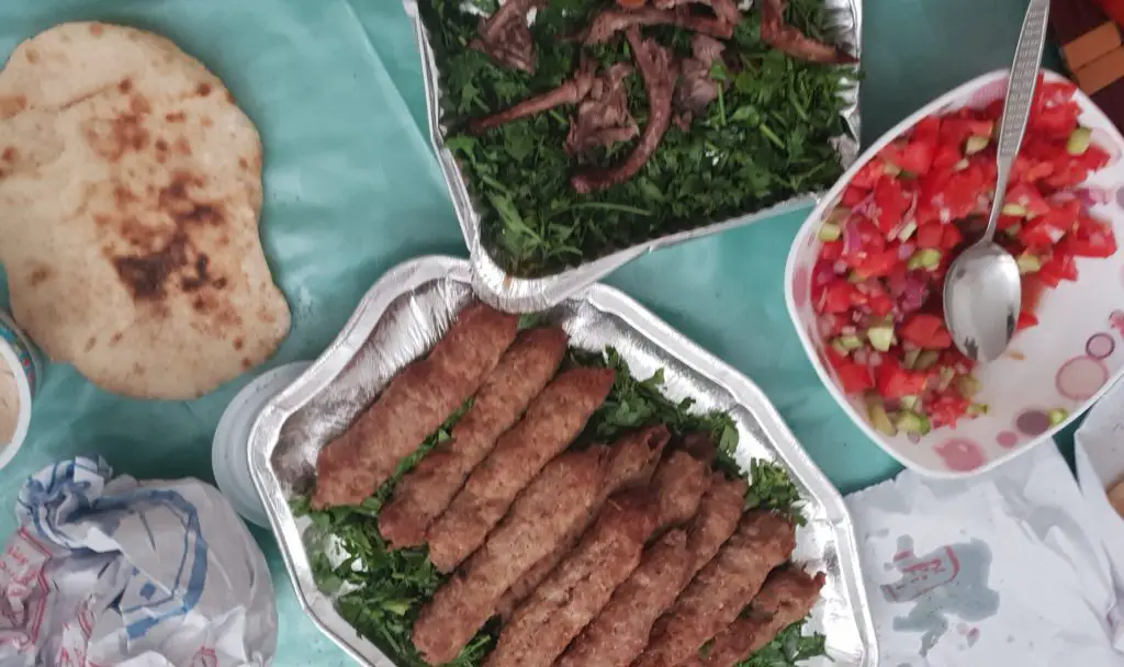 Egyptain food of kebab, salad, flat bread and kofta