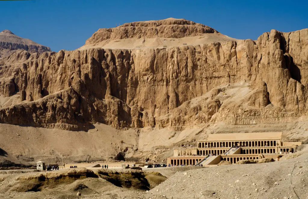 Temple of Hatchetsut with rock wall towering behind