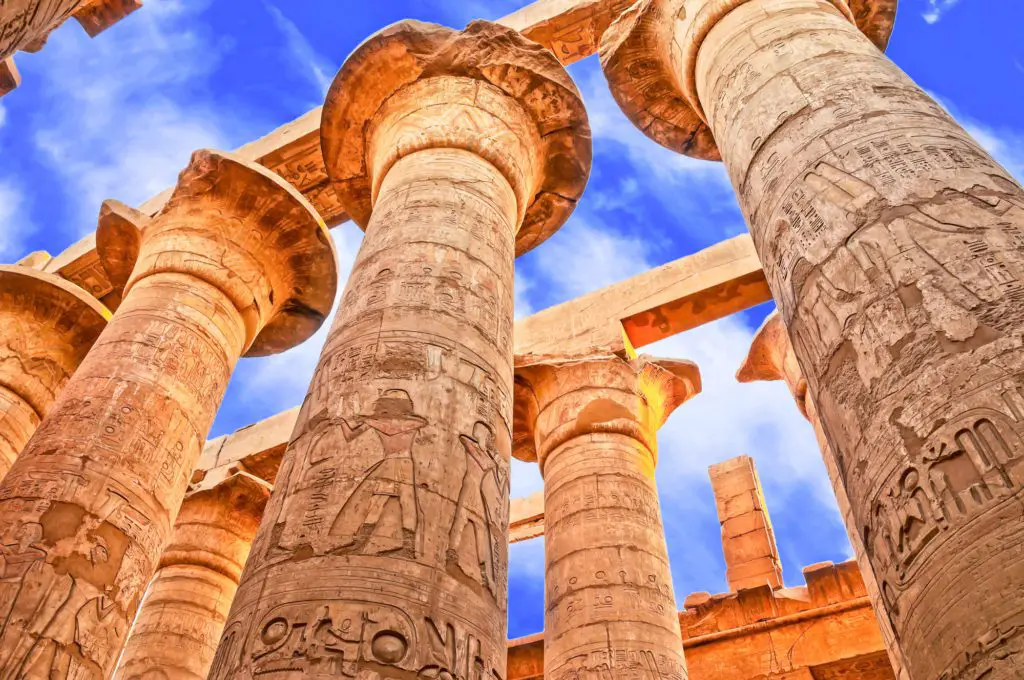 colums looking toward the sky with hieroglyphics inscribed -  Egypt on a budget
