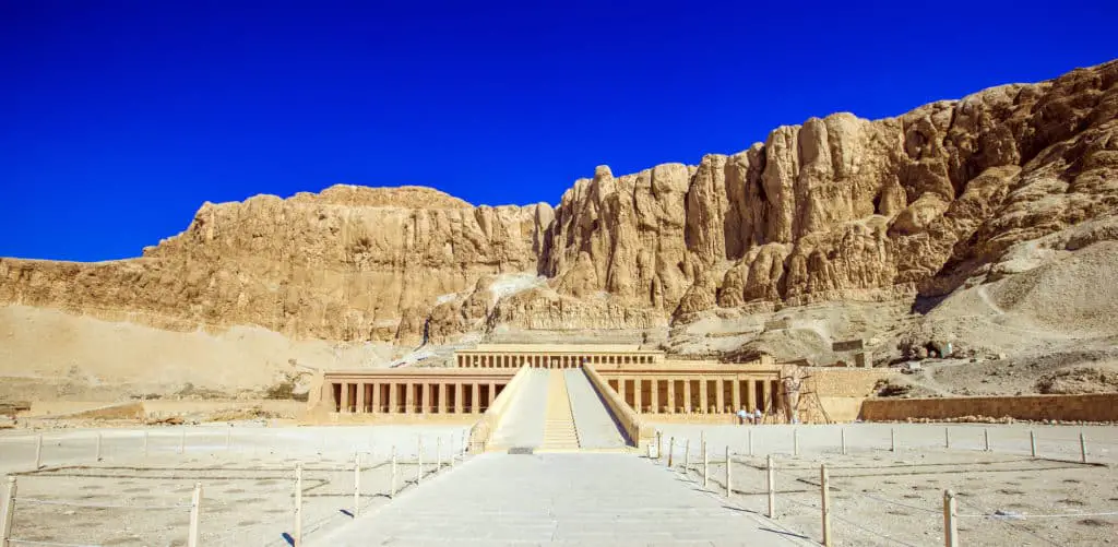 front on view of Hatshepsut Temple, Egypt with cliff walls behind