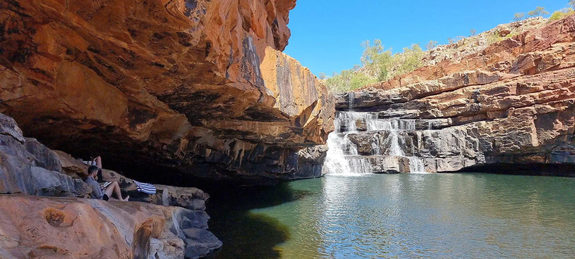 a layered waterfall over red rock at Bell Gorge kimberley's