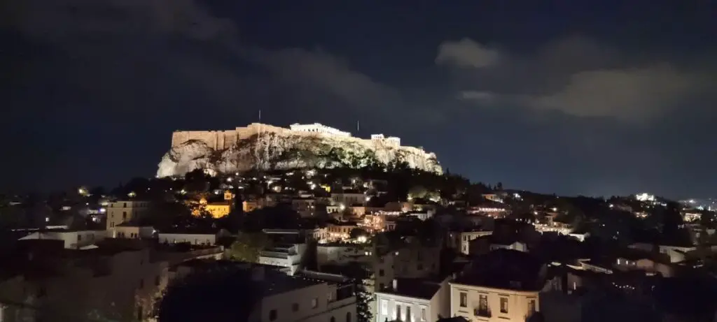 the Acropolis at night lit up on our mainland Greece itinerary