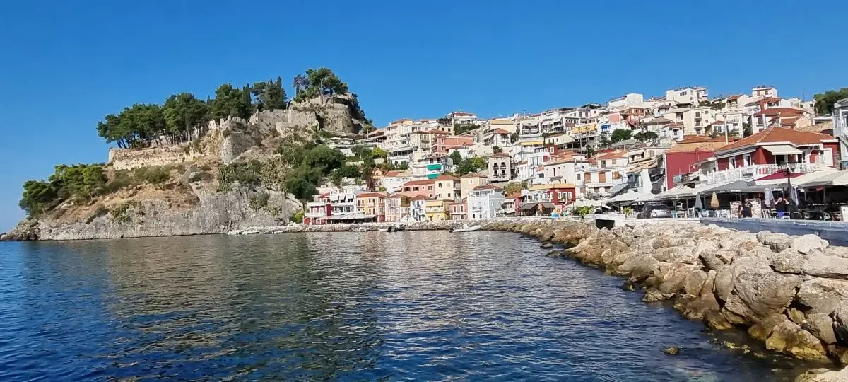 The gorgeous town of Parga showing the many colorful houses nestles on the shoreline on our mainland Greece itinerary
