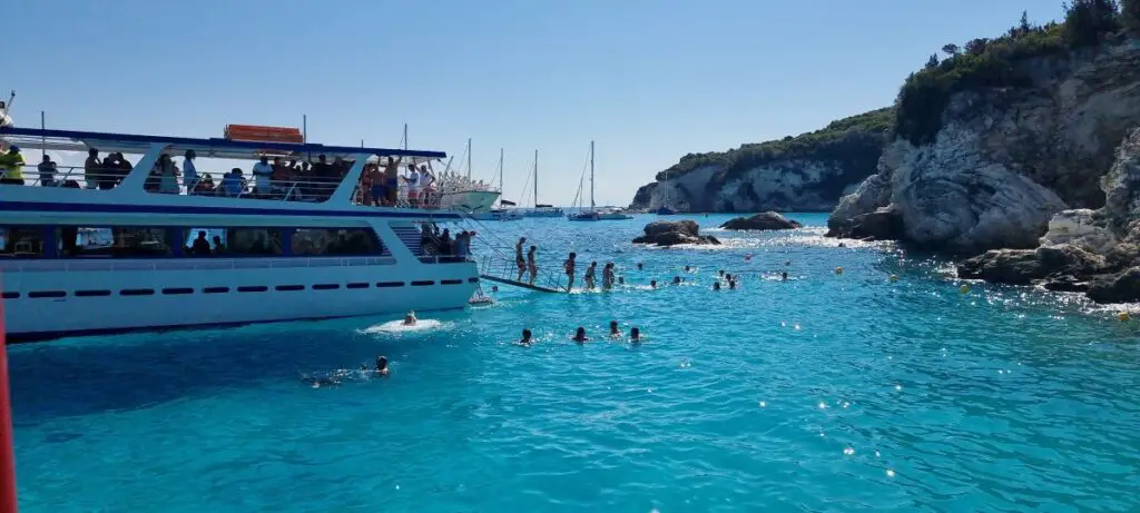 people walking the stairs off the boat on Antipaxos Island