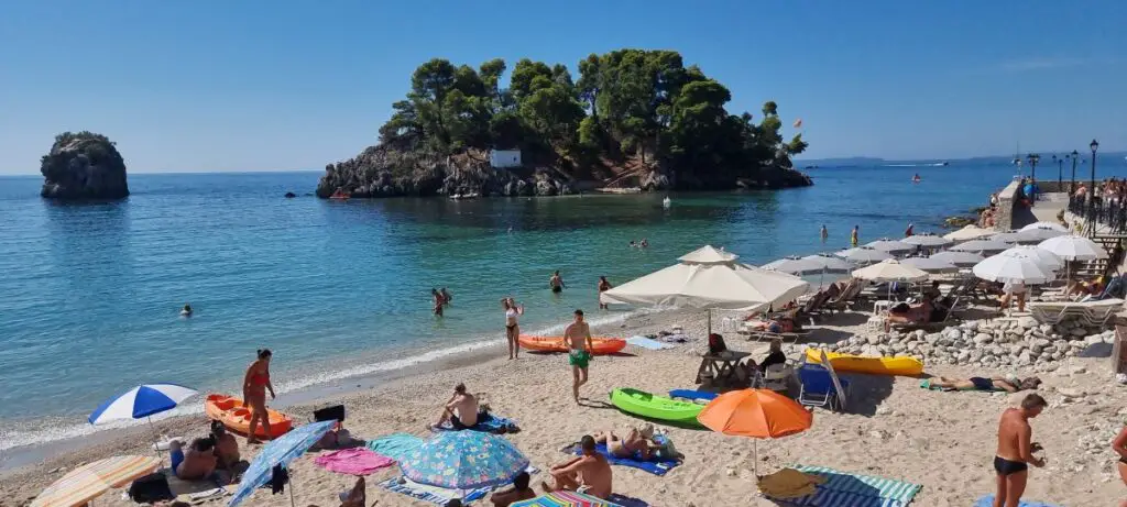 beach goers on the sand with in Parga